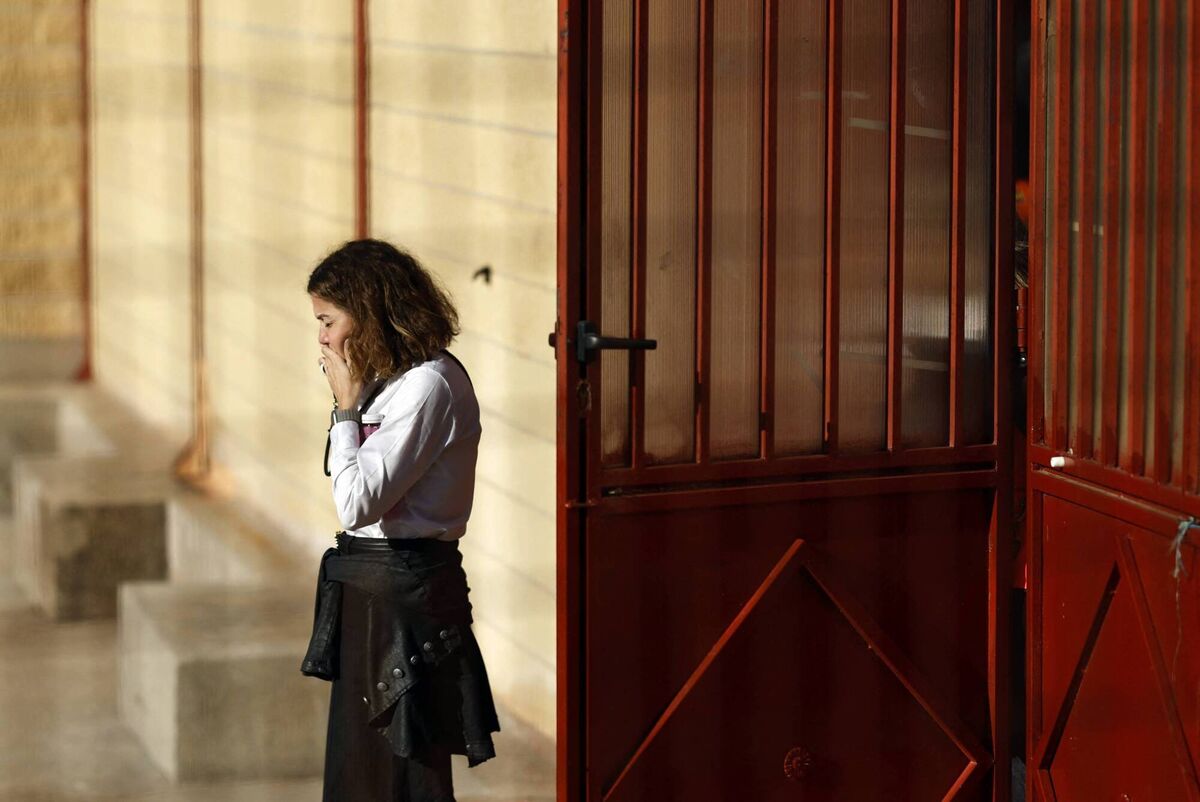 A woman uses her telephone at the entrance of a support center for relatives of missing victims in Urda, following the train crash between a high-speed Renfe AVE train and an Iryo train around 150 km south of Madrid between Urda and Los Yebenes in the province of Toledo, on October 28, 2026. Picture: Oscar DEL POZO / AFP via Getty Images