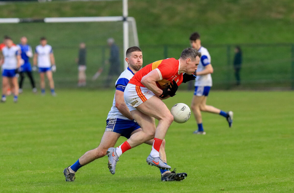 Éire Óg defender Mark Griffin is tackled by Knocknagree's David Twomey. Picture: David Creedon