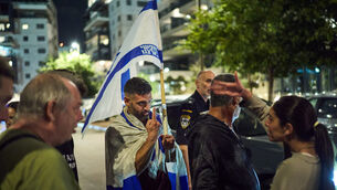 A supporter of Israeli Prime Minister Benjamin Netanyahu, right, is held back while arguing with left-wing activists calling for a government with Arab parties (David Goldman/AP) A supporter of Israeli Prime Minister Benjamin Netanyahu, right, is held back while arguing with left-wing activists calling for a government with Arab parties (David Goldman/AP)