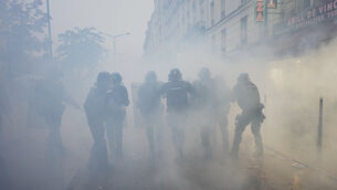 Police officers run toward protesters during a demonstration against rising living costs in Paris last weekend (AP Photo/Thibault Camus)