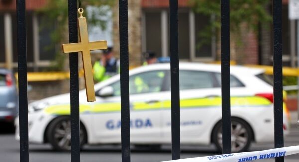 A cross on railings at the Gareth Hutch murder scene.