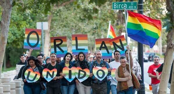 Several hundred supporters, led by Laura Kanter, at right, marched to Sasscer Park in Santa Ana, California, after a vigil at Calle Cuatro Plaza in support of the Orlando shooting victims. Pic: AP