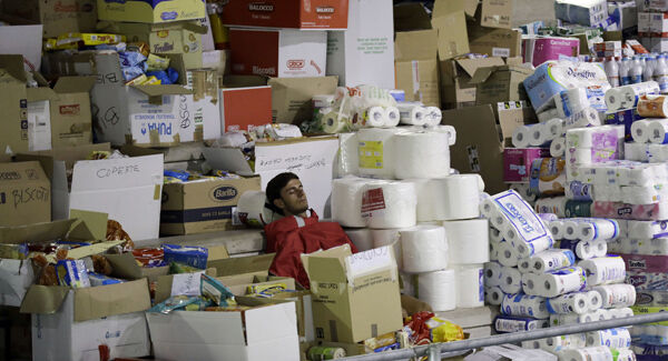 A volunteer takes some rest in a makeshift camp set up inside a gymnasium following the earthquake in Amatrice. Picture: AP A volunteer takes some rest in a makeshift camp set up inside a gymnasium following the earthquake in Amatrice. Picture: AP