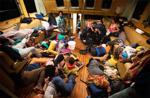 Refugees from Eritrea rest inside the Astral vessel after being rescued from the Mediterranean sea. Pic: PA