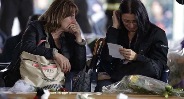 Two women cry ahead of the state funeral for some of the victims of last Wednesday's earthquake. Pic: AP Two women cry ahead of the state funeral for some of the victims of last Wednesday's earthquake. Pic: AP