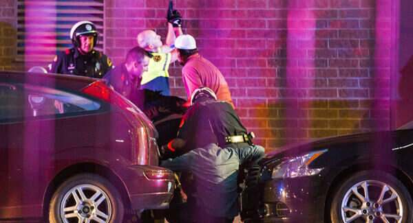 Dallas Police shield bystanders after shots were fired. Picture: Smiley N. Pool/The Dallas Morning News via AP.