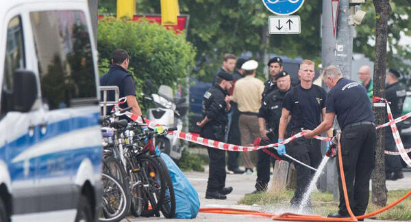Police stand at the crime scene.