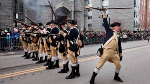 American Revolutionary War re-enactors fire musket blanks during a St Patrick’s Day parade in Boston. This year’s has been cancelled.