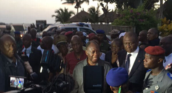 Ivory Coast's President Alassane Ouattara, center, visits the area were gunmen attacked people in Grand Bassam, Ivory Coast, yesterday. Pic: AP