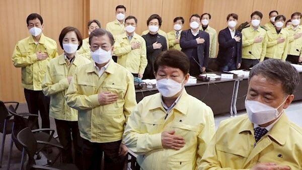 South Korean President Moon Jae-in, third from right, salutes during a special government meeting to discuss measures to prevent the further spread of COVID-19 at the Daegu City Hall in Daegu, South Korea, Tuesday, Feb. 25, 2020. (Han Sang-kyun/Yonhap via AP)