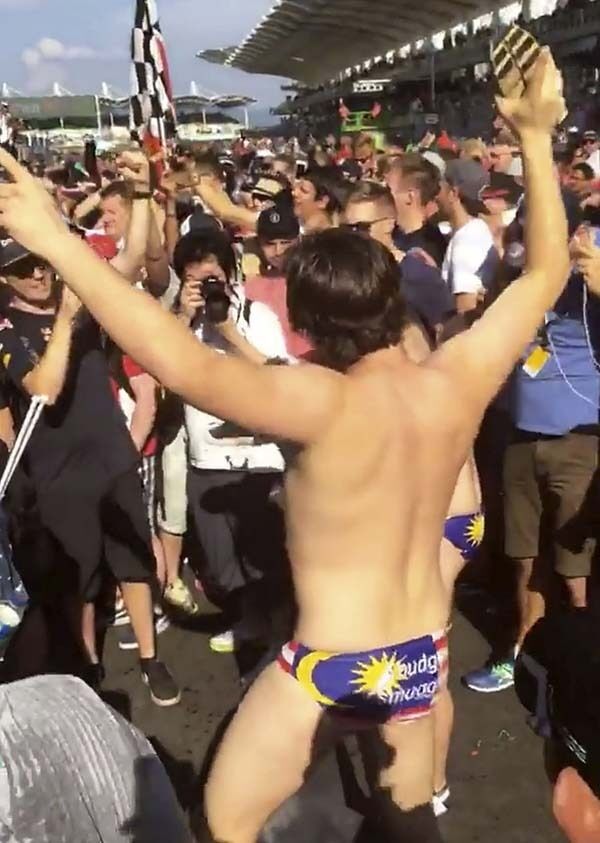 An image made from video (above) supplied by Umar Akif Jamaludin of an Australian man dancing at the conclusion of the Malaysian Formula One Grand Prix in Sepang, Malaysia. An image made from video (above) supplied by Umar Akif Jamaludin of an Australian man dancing at the conclusion of the Malaysian Formula One Grand Prix in Sepang, Malaysia.