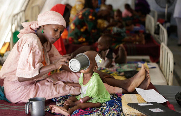 A mother feeds her malnourished child at a feeding centre run by Doctors Without Borders in Maiduguri, Nigeria. A mother feeds her malnourished child at a feeding centre run by Doctors Without Borders in Maiduguri, Nigeria.