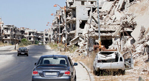 Damaged buildings and rubble line a street in Homs, Syria, Sept. 19, 2016.