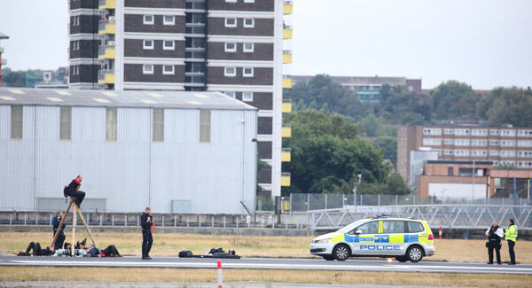 Protesters on the runway this morning. Picture: PA