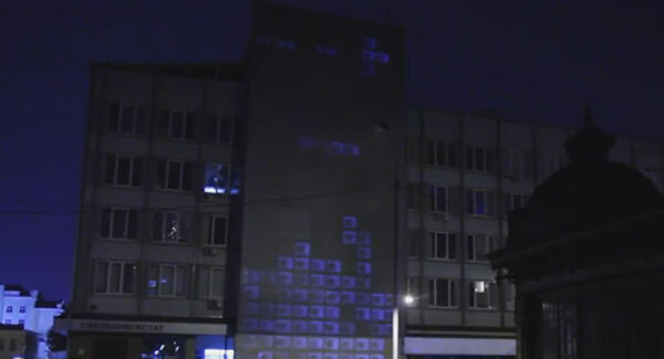 Watch as street artists beam games of Tetris onto sides of buildings