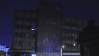 Watch as street artists beam games of Tetris onto sides of buildings