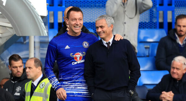 Chelsea's John Terry and Manchester United manager Jose Mourinho embrace on the touchline prior to the match. Photo: John Walton/PA