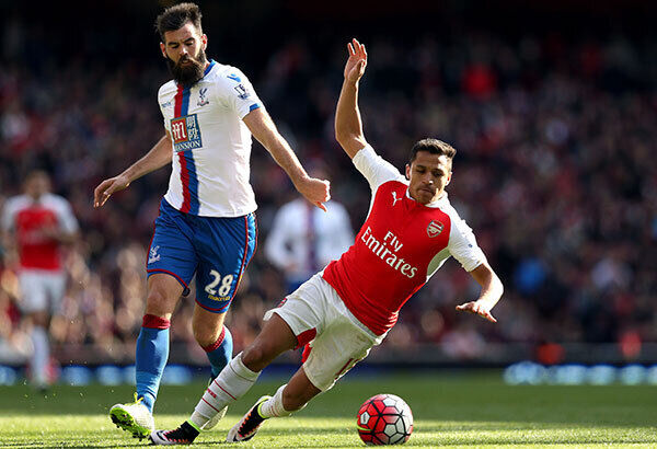 Arsenal's Alexis Sanchez and Crystal Palace's Joe Ledley battle for the ball at the Emirates Stadium. Photo: Adam Davy/PA