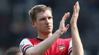 Arsenal defender Per Mertesacker: Title battle 'not totally over yet'