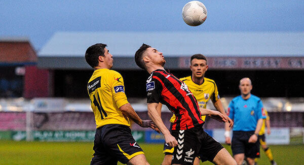 Eoin Wearen, Bohemians, in action against Kevin O'Connor, Longford Town. Photo: Seb Daly / SPORTSFILE