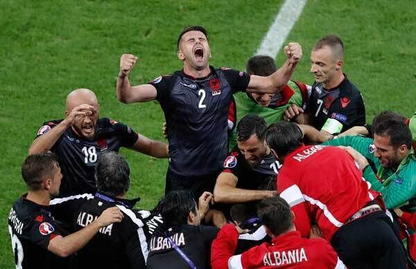 Albania's Andi Lila shouts and raises his arms while celebrating his team's goal at the Grand Stade. AP Photo/Michael Sohn