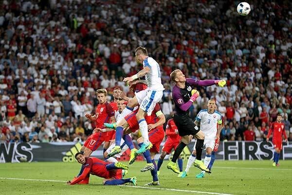 England goalkeeper Joe Hart punches clear from a crowded penalty area. Photo: Owen Humphreys/PA