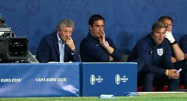 England manager Roy Hodgson (left) and coach Gary Neville (centre) sit dejected on the bench. Photo: Nick Potts/PA
