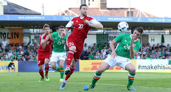 Ireland's Ciaran Clark has an attempt on goal as Mikhail Sivako of Belarus watches on. Photo: INPHO/Cathal Noonan