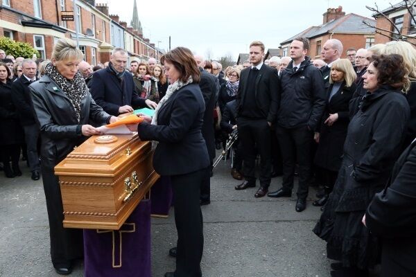 An Irish flag is placed upon the coffin watched by his wife Bernadette (Bernie, far right) and close family ahead ahead of the funeral. Photo credit: Paul faith/PA Wire An Irish flag is placed upon the coffin watched by his wife Bernadette (Bernie, far right) and close family ahead ahead of the funeral. Photo credit: Paul faith/PA Wire
