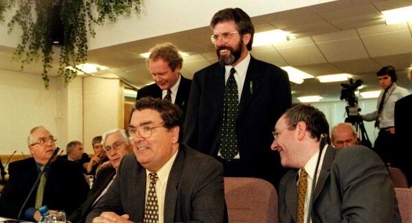 Martin McGuinness (rear) and Gerry Adams talk with SDLP Assembly members led by party leader John Hume (seated centre) during the first sitting of the newly-elected Assembly at Stormont in 1998. Pic: PA