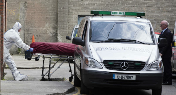 Michael Keogh's body is removed from the scene. Michael Keogh's body is removed from the scene.