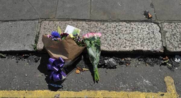 Floral tributes left at the roadside next to burnt debris from a fire that engulfed the 24-storey Grenfell Tower in west London. Floral tributes left at the roadside next to burnt debris from a fire that engulfed the 24-storey Grenfell Tower in west London.