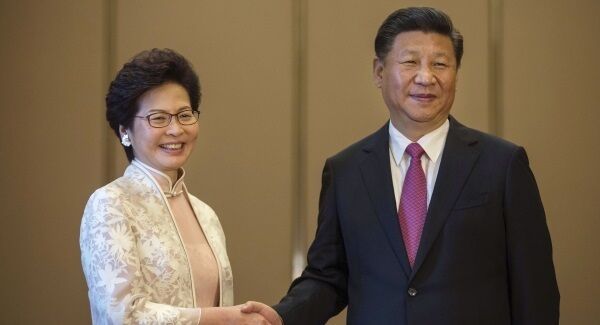 Chinese President Xi Jinping poses with Hong Kong's Chief Executive Carrie Lam ahead of a meeting in Hong Kong today. Pic: AP
