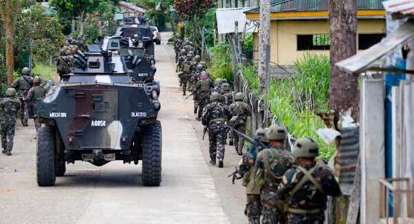 Philippines vows to save hostages as fighting rages on in siege city
