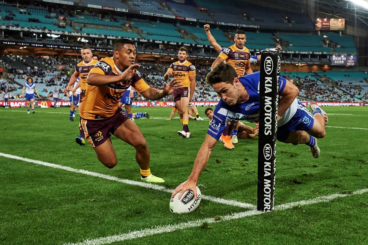 Canterbury Bulldogs’ Nicholas Meaney squeezes in for a try during an NRL match with Brisbane Broncos at ANZ Stadium, Sydney on Sept 7. Picture: Brett Hemmings