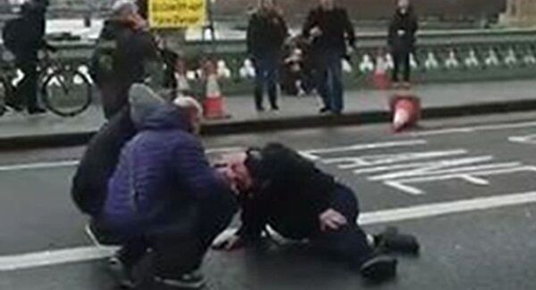 Screengrab from a video posted on the twitter feed of @sikorskiradek of people attending to a person on Westminster Bridge, London.