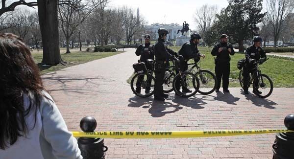 US Secret Service officers stand in the cordoned off Lafayette Park after a security incident near the fence of the White House in Washington on Saturday. Pic: AP