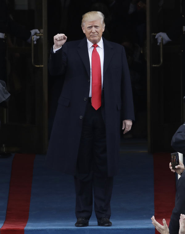 President-elect Donald Trump pumps his fist as he arrives for his Presidential Inauguration at the US Capitol in Washington. (AP Photo/Patrick Semansky)