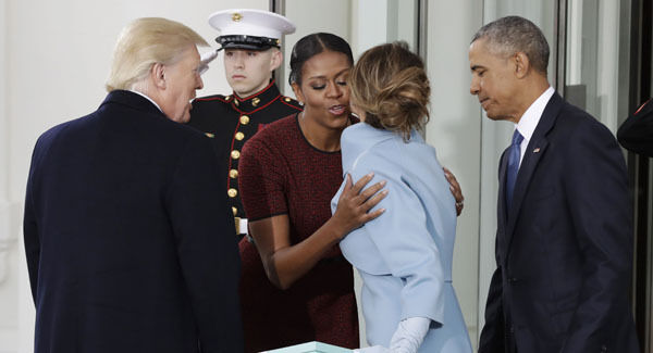 Michelle Obama, flanked by President Barack Obama and President-elect Donald Trump, greets Melania Trump at the White House in Washington. Picture: AP
