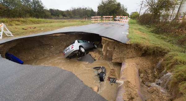 Sheriff's deputy dies after car falls into sinkhole
