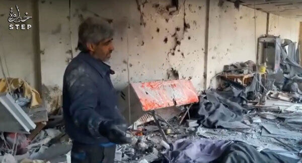 A man views scenes of destruction inside a banquet hall, in Deir Qanoun, Barada Valley, Syria.
