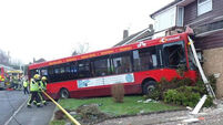 Bus crashes into house