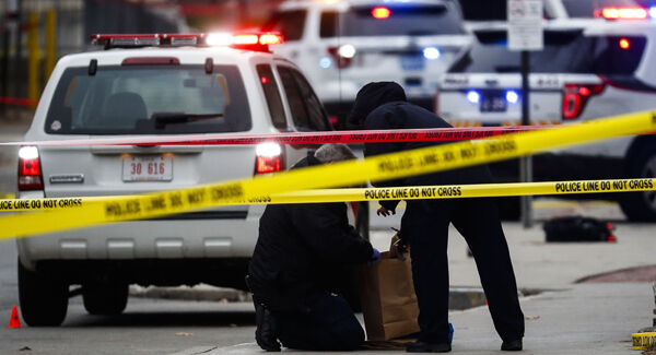 Crime scene investigators collect evidence from the pavement outside Ohio State University. Picture: AP