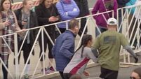 Watch fellow runners come to rescue as woman struggles to reach half-marathon finish line