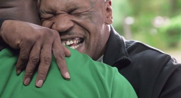 Mike Tyson hugs Evander Holyfield. Mike Tyson hugs Evander Holyfield.