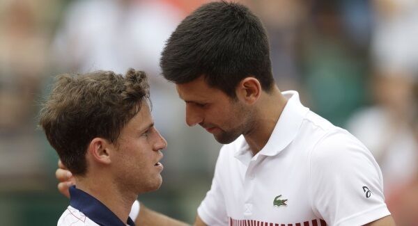 Novak Djokovic, right, talks to Argentina's Diego Schwartzman after their third round match today.