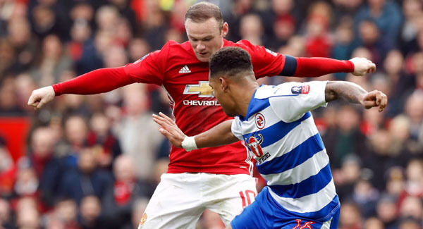 Manchester United's Wayne Rooney (left) and Reading's Liam Moore battle for the ball. Picture: PA