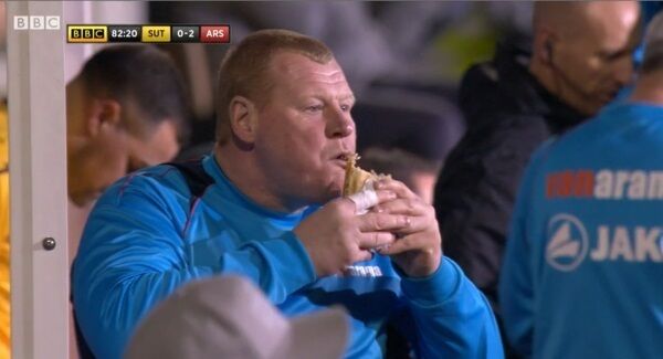 Sutton goalkeeper Wayne Shaw eating a pie at last night's game. Pic: PA