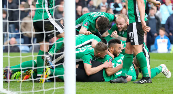 Lincoln City's Sean Raggett celebrates scoring at Turf Moor. Photo: Martin Rickett/PA