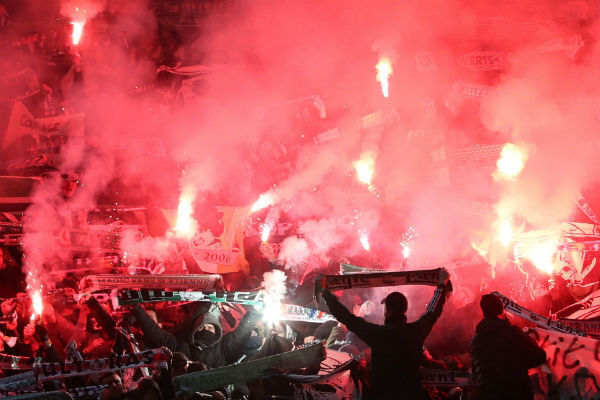 Flares in the stands at Old Trafford. Photo: Martin Rickett/PA Flares in the stands at Old Trafford. Photo: Martin Rickett/PA